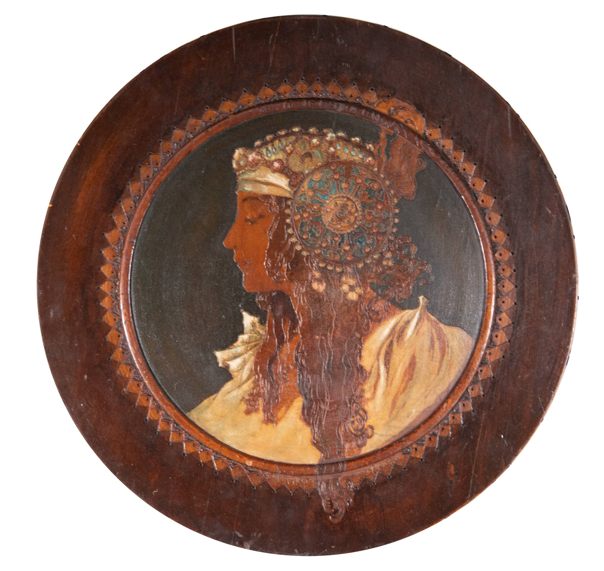 Circular wood plaque of the profile portrait of a woman.